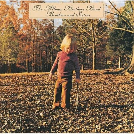 The Allman Brothers Band Ramblin’ Man Brothers and Sisters (1973) album cover featuring young boy seated with rustic Southern backdrop.