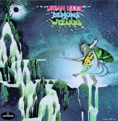 Album cover of uriah heep demons wizards featuring a fantasy wizard figure balancing on icy rock formations in a surreal snowy landscape under a starry sky.