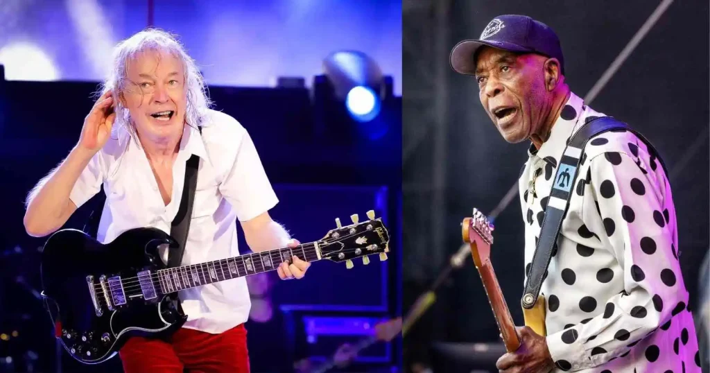Angus Young playing guitar on stage alongside blues legend Buddy Guy, both mid-performance.