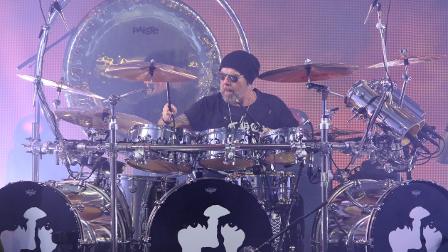 Jason Bonham Commands the Stage During Led Zeppelin Evening Performance - Classic Rock Artists Jason Bonham Led Zeppelin drummer performing live behind massive drum kit with purple stage lighting,