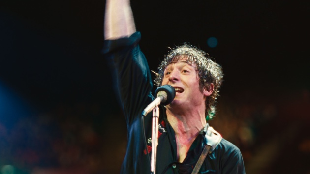 Jeremy Allen White's leap of faith playing Bruce Springsteen in biopic - Classic Rock Artists Jeremy Allen White performs as Bruce Springsteen on stage with microphone and raised fist.