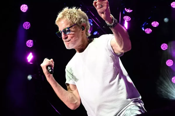 Kevin Cronin heartbreaking decision as he performs live on stage with microphone in hand.