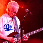 Robby Krieger of The Doors playing guitar live on stage during a tribute performance.