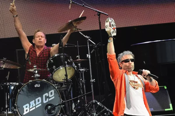 Bad Company's Simon Kirke and Paul Rodgers Perform Live - Classic Rock Artists Bad Company Rock and Roll Hall of Fame inductees Simon Kirke on drums and Paul Rodgers singing on stage during live performance.