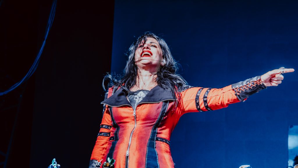 Lacuna Coil Dominate Bloodstock Stage - Classic Rock Artists Lacuna Coil performing at Bloodstock, vocalist in red and black commanding the stage with energy.