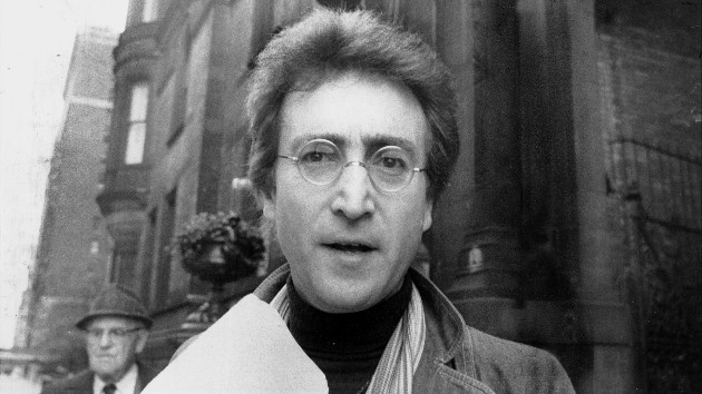 John Lennon smiling with long hair and sunglasses during his New York City years in the 1970s
