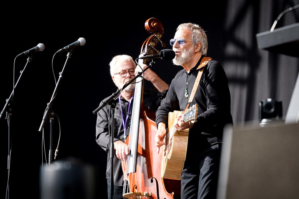 Yusuf/Cat Stevens Performs "Peace Train" at Christchurch Memorial Service - Classic Rock Artists Cat Stevens tour performer Yusuf Islam playing acoustic guitar at the National Remembrance Ceremony in Christchurch, New Zealand, 2019.