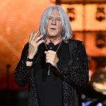 Joe Elliott of Def Leppard performing live on stage with microphone, announcing details about Def Leppard new album during Summer Stadium tour at Truist Park in Atlanta.