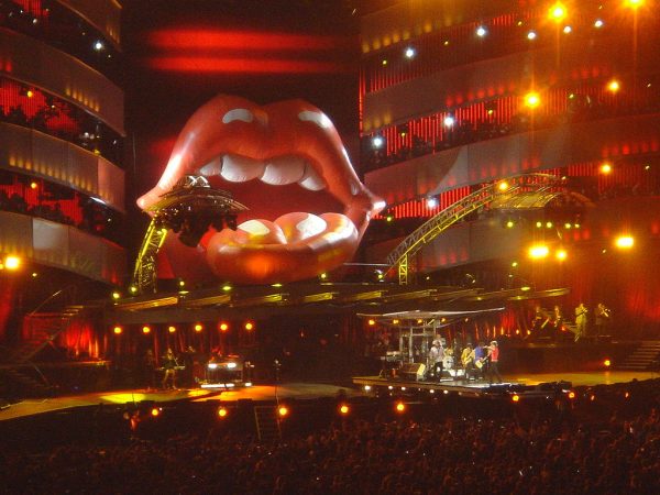Rolling Stones Concert - Members of the Rolling Stones Live Performance Members of the Rolling Stones performing live on stage beneath giant iconic tongue and lips logo during concert tour