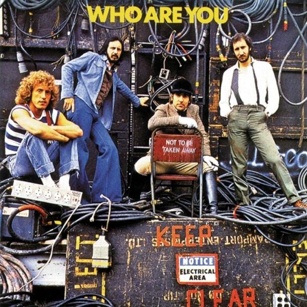 The Who - Who Are You Album Cover - Classic Rock Artists The Who Are You Super Deluxe album cover showing The Who band members posed among electrical equipment and cables with "WHO ARE YOU" text above and warning signs below.