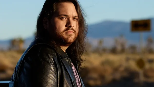 Wolfgang Van Halen Refuses to Play Father's Songs - Forging His Own Path - Classic Rock Artists Wolfgang Van Halen refuses to compromise his artistic vision - portrait of the Mammoth frontman in leather jacket against desert landscape.