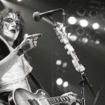 Ace Frehley - The Spaceman - KISS Legend in Concert - Classic Rock Artists Farewell to the Spaceman - Ace Frehley performing live with KISS in his iconic silver Spaceman makeup and costume, playing his Les Paul guitar.