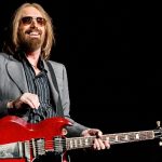 Tom Petty Collectibles - Legendary Rocker with Iconic Red Guitar - Classic Rock Artists Tom Petty performing live with his signature red guitar, perfect for collectors seeking Tom Petty collectibles