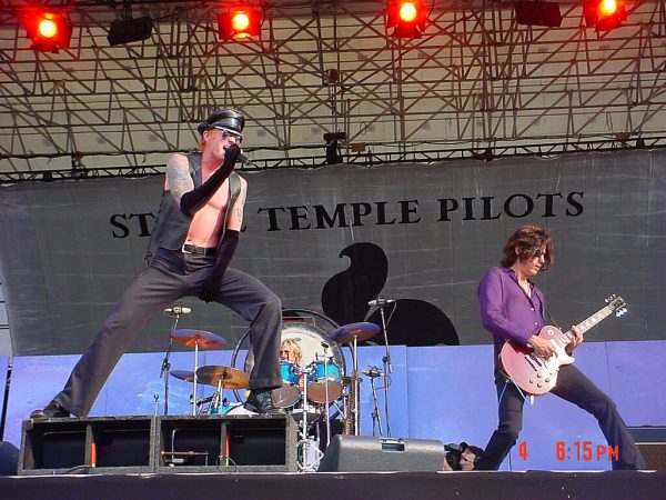 Stone Temple Pilots members performing live on stage with vocalist and guitarist