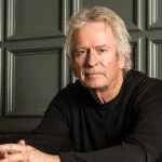 Tony Banks Biography: 'Man Of Spells' Set for Feb 2026 - Classic Rock Artists - Classic Rock Artists Formal portrait of Tony Banks, Genesis keyboardist, sitting and looking at the camera. This image relates to the new Tony Banks biography 'Man Of Spells'