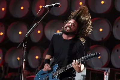 Foo Fighters 2026 Tour announcement featuring Dave Grohl and band performing live on stage with intense lighting and crowd energy at stadium concert