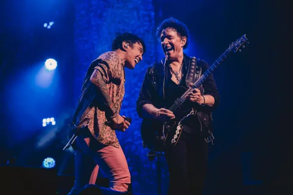 Journey Tour 2026 - Arnel Pineda and Neal Schon Live Performance Journey Tour 2026 featuring Arnel Pineda and Neal Schon performing live on stage with blue stage lighting