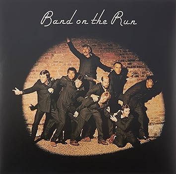 Band on the Run by Paul McCartney and Wings album cover featuring spotlight prisoners breaking free 1973