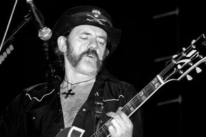 Lemmy Kilmister performing live with his signature Rickenbacker bass guitar and iconic mutton chops