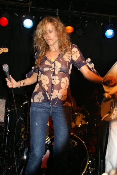 Sheryl Crow performing live with electric guitar