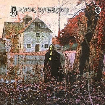 Black Sabbath Black Sabbath 1970 debut album cover featuring mysterious woman in front of Mapledurham Watermill.