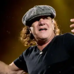 Brian Johnson performing AC/DC Jailbreak live on stage wearing signature flat cap during Power Up tour 2025