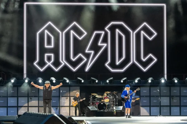 Brian Johnson and Angus Young of AC/DC performing Thunderstruck live on stage at Murrayfield Stadium in Edinburgh with iconic lightning bolt logo backdrop