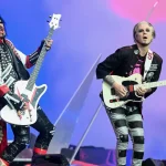 Motley Crue's setlist change features Nikki Sixx and John 5 performing live on stage with matching white guitars during their concert tour