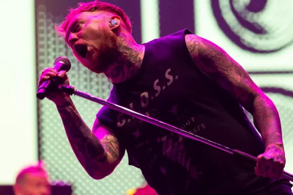 Sex Pistols tour 2026 frontman Frank Carter performing live on stage with microphone
