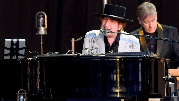 Bob Dylan 2026 tour dates concert performance on stage with keyboard and harmonica.