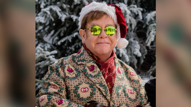 Elton John Step Into Christmas platinum certification celebrates holiday classic with festive Santa hat and signature sunglasses