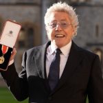 Sir Roger Daltrey displays his knighthood medal after receiving the honor at Windsor Castle for his contributions to music and charity