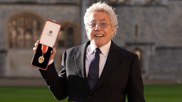 Sir Roger Daltrey displays his knighthood medal after receiving the honor at Windsor Castle for his contributions to music and charity