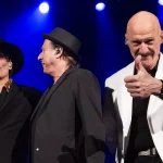 King Crimson Beat band members Adrian Belew Tony Levin and Danny Carey performing on stage 2026 tour.