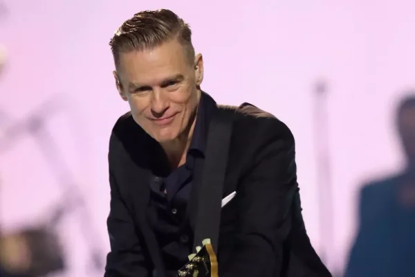 Bryan Adams performing live on stage during his tour, showcasing what fans can expect from the Bryan Adams tour 2026