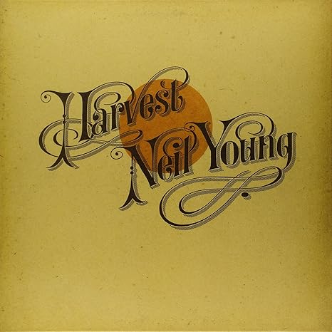 Neil Young Harvest Album: From the Middle of the Road to the Ditch 2 Neil Young Harvest album original 1972 cover with ornate Victorian typography on golden yellow background featuring decorative lettering and harvest moon graphic