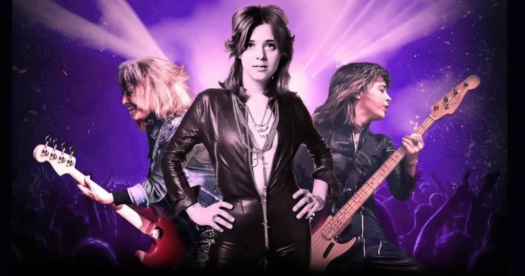 Suzi Quatro tour 2026 promotional image showing the rock legend in black leather with bass guitar against purple stage lighting.
