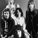 Members of Yes band 1972 classic lineup featuring Rick Wakeman, Jon Anderson, Chris Squire, Bill Bruford, and Steve Howe in black and white press photo.
