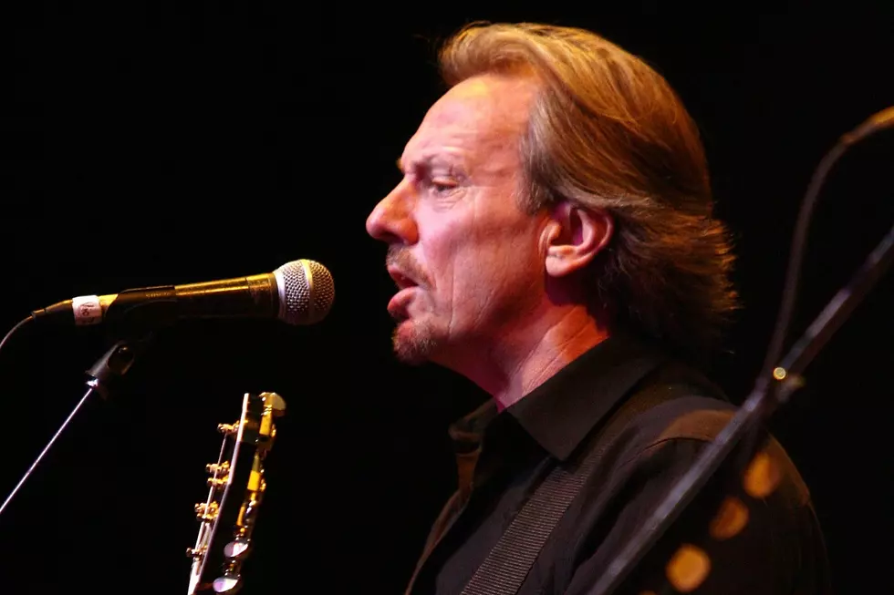America tour 2026 featuring founding member Dewey Bunnell performing live with guitar at The Happy Trails Tour concert.