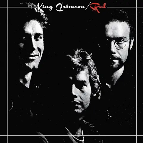 King Crimson Providence Red album cover 1974 featuring Robert Fripp John Wetton Bill Bruford dramatic black and white chiaroscuro portrait.
