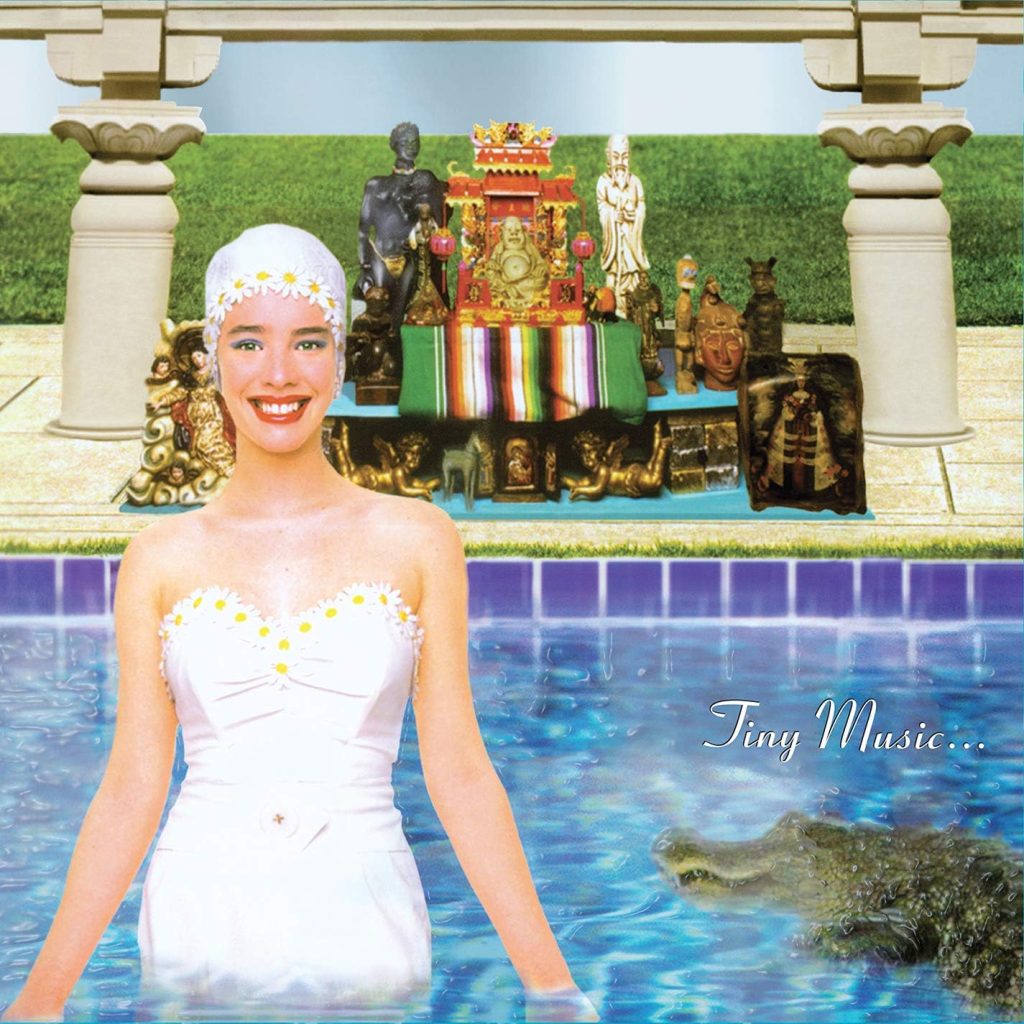 Tiny Music stp album cover artwork featuring surreal poolside imagery representing the band’s experimental 1996 release.