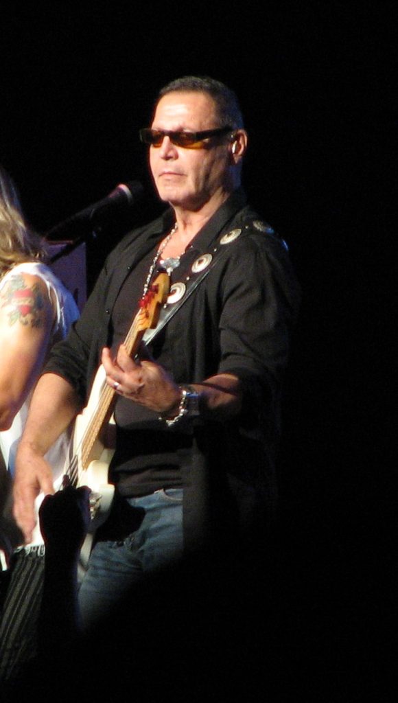 Chuck Panozzo performing live on stage as bassist and co-founder of Styx