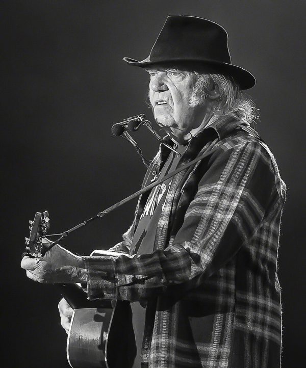 Neil Young performing live with his iconic Old Black 1953 Gibson Les Paul guitar