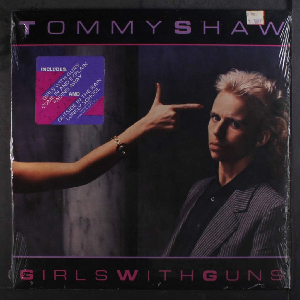 Tommy Shaw Girls With Guns album cover featuring the guitarist in 80s style.