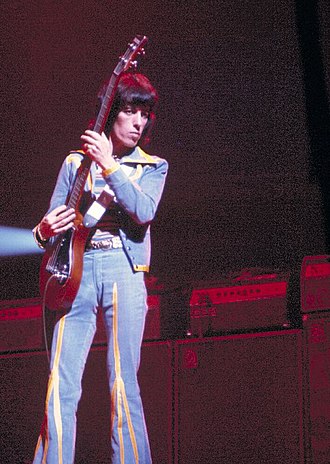 Bill Wyman: The Quiet Stone Who Shaped Rock History 1 Bill Wyman performing with the Rolling Stones on stage in 1975