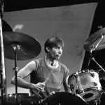 Charlie Watts performing live on his drum kit during a Rolling Stones tour.