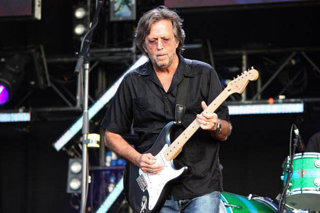 Eric Clapton performing live on stage with his signature guitar