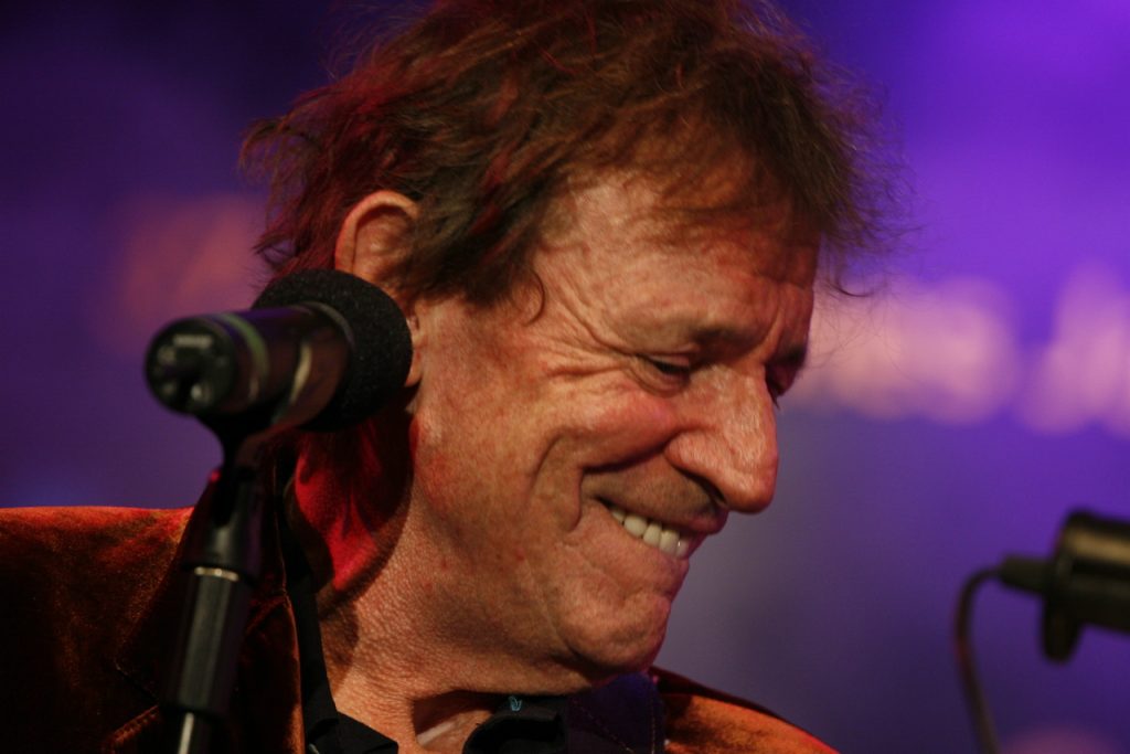 Jack Bruce performing live on stage, iconic bassist and vocalist of Cream