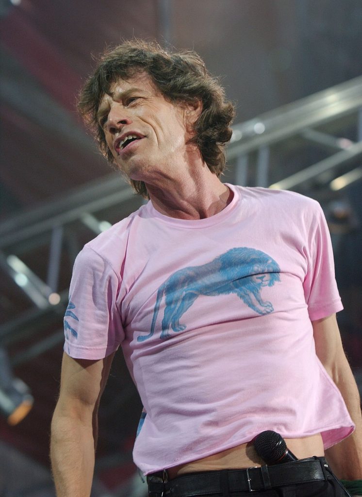Mick Jagger performing live on stage in concert.