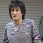 Ronnie Wood promotional photo. Just him posing with a long leace blend shirt with a nickles hanging around his neck.